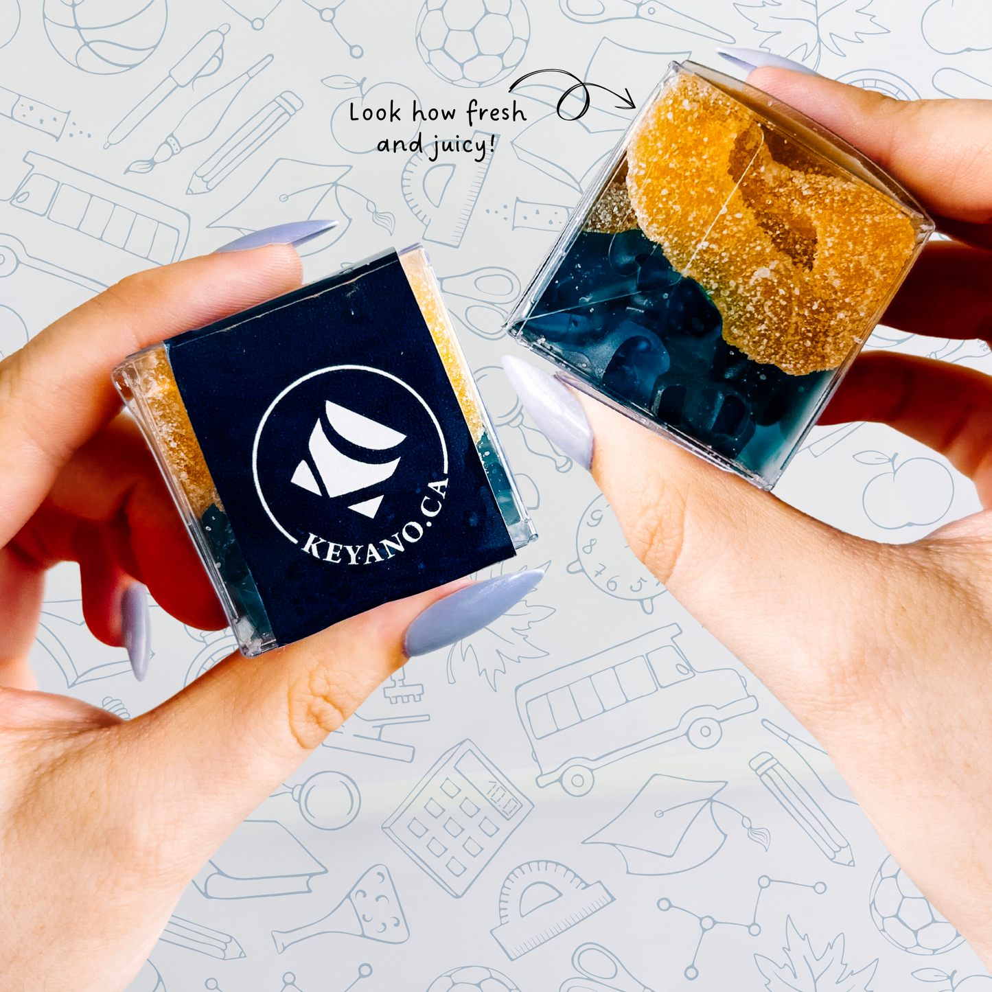 Hands holding a CandyGram to show the front Keyano College logo sticker and the side view of the candy mix.