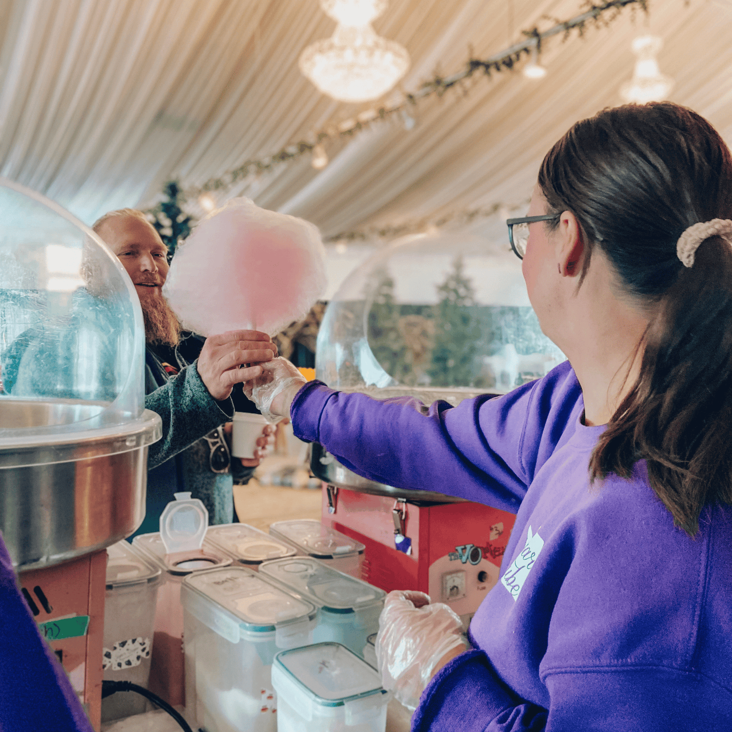 Fresh-spun pink cotton candy being served to a guest at an event in Calgary.