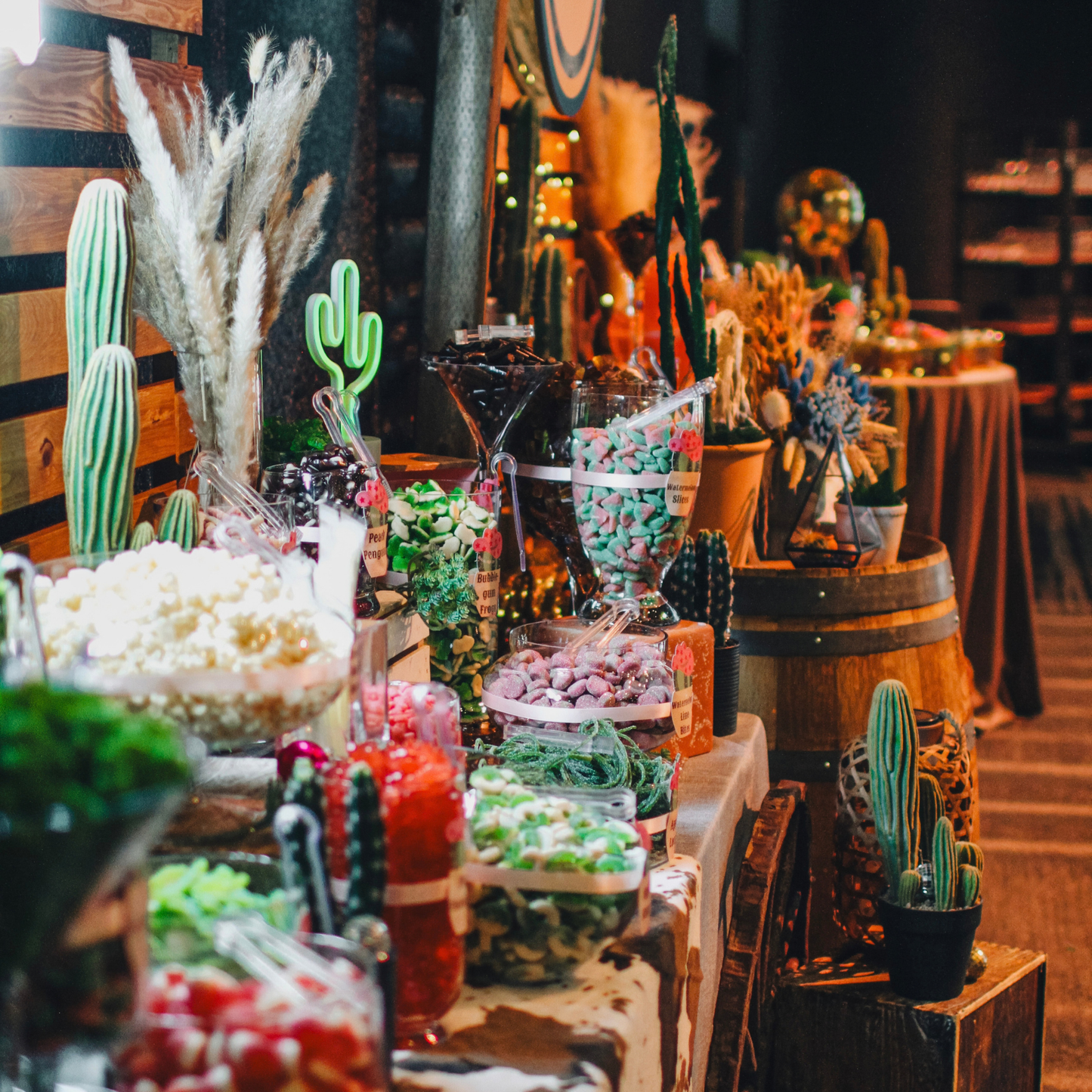 Professionally styled western-themed candy buffet with premium candy, glass vessels and event decor