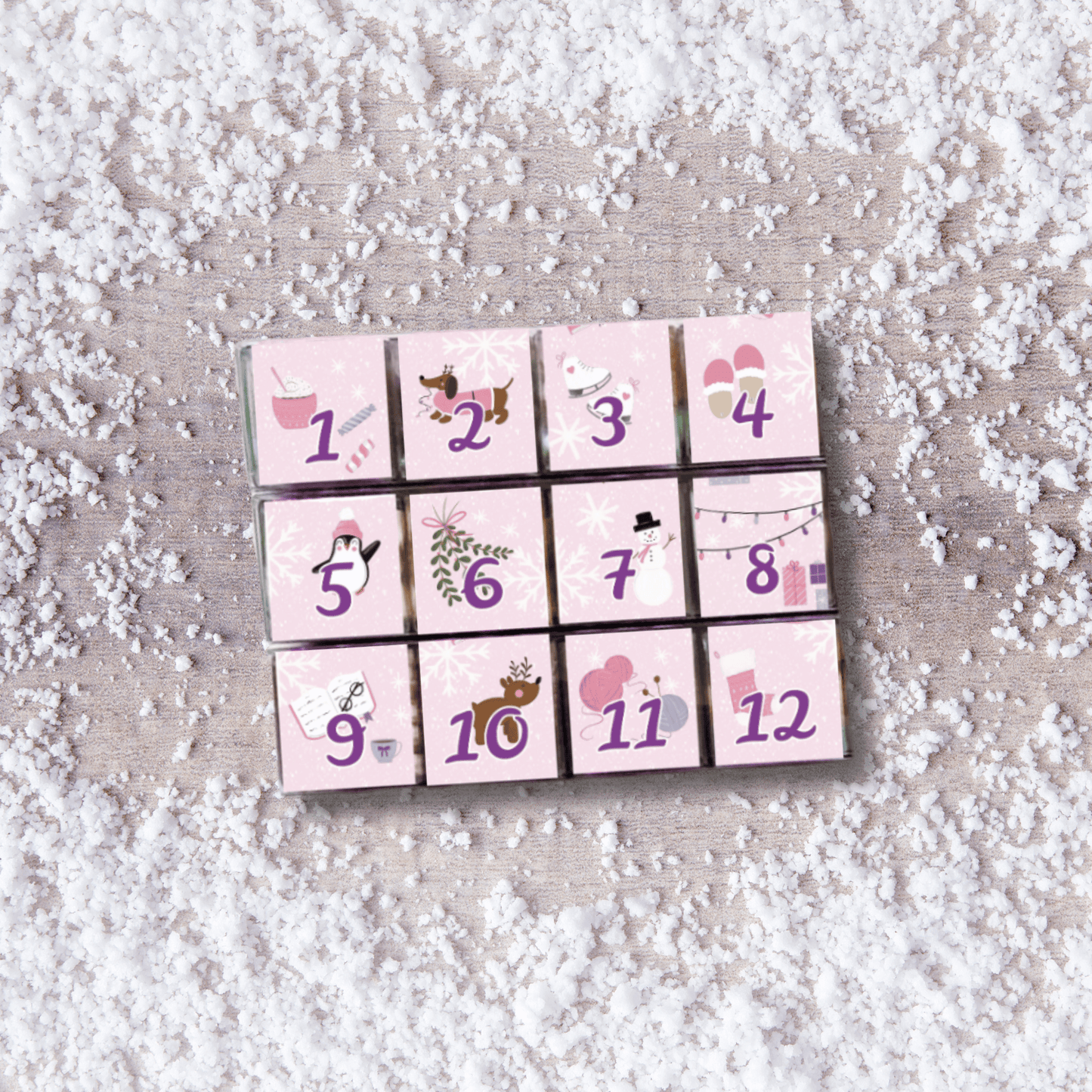 The Sugar Cube 12-day mini candy Advent calendar with 12 numbered candy-filled cubes, pink holiday artwork and allergen-friendly options.