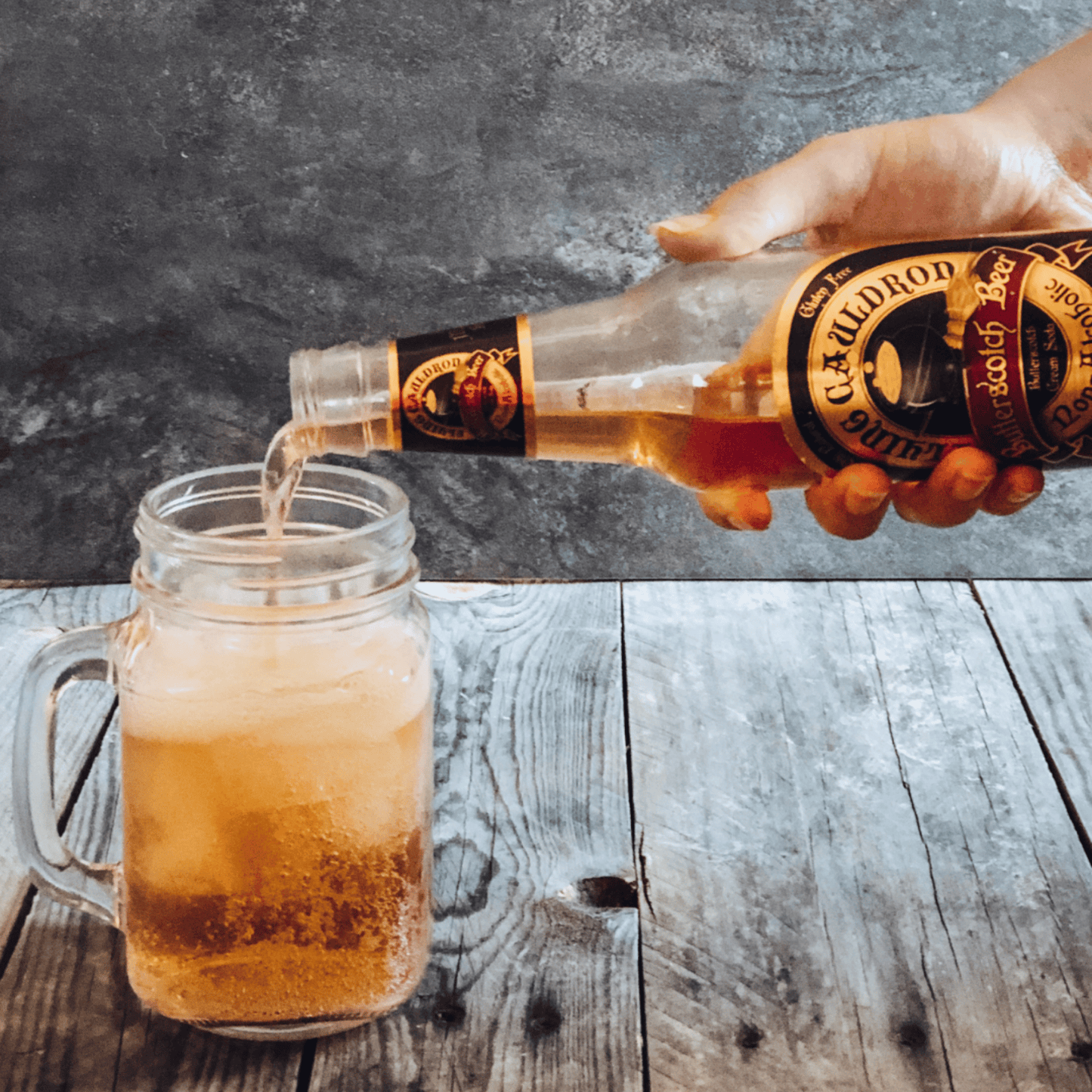 Butterbeer butterscotch cream soda being poured into a glass mug