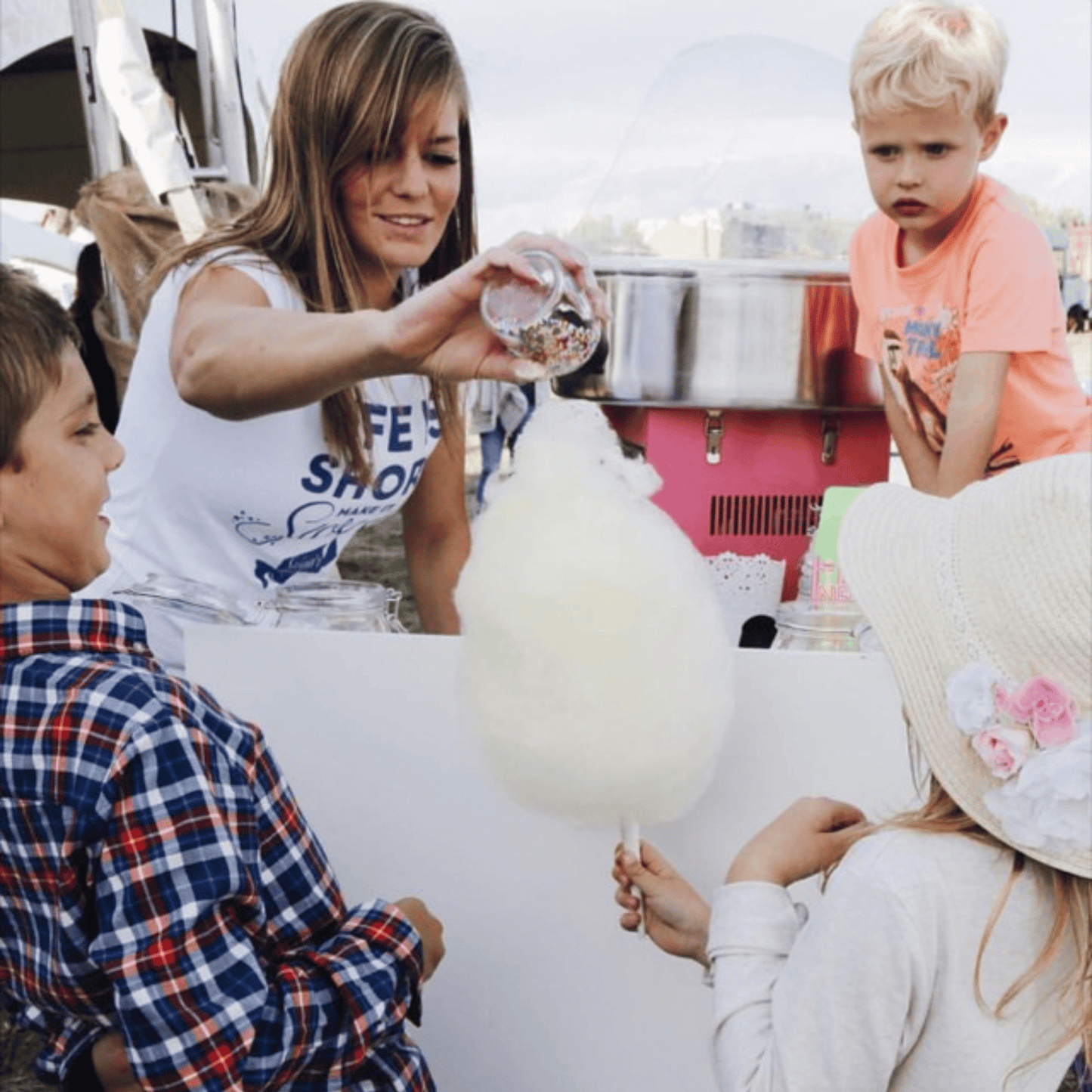 Fresh cotton candy being spun and served to guests at an outdoor event in Calgary.