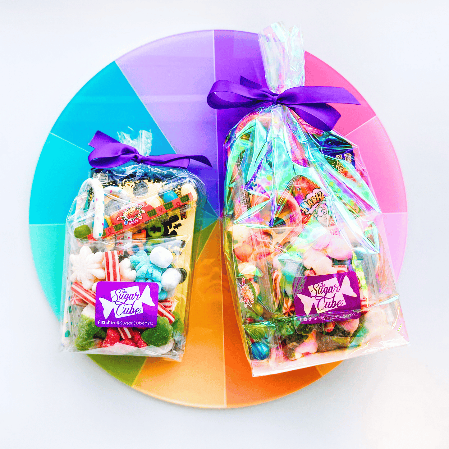 Regular and large Christmas stocking stuffer gift bags filled with festive candy and individually wrapped treats