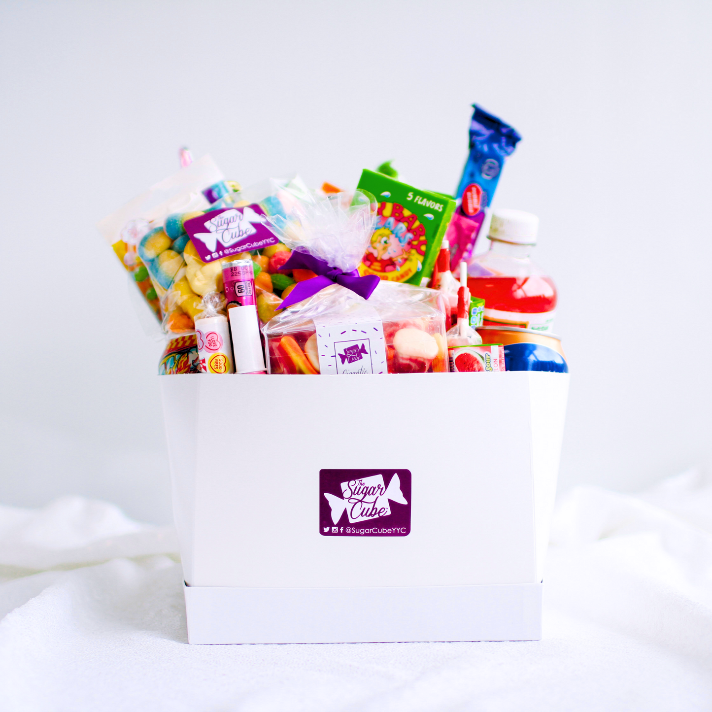 Extra Large candy gift basket packed with approximately 40 to 50 assorted treats, including specialty soda bottles and cans
